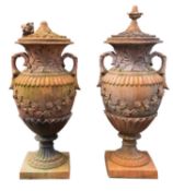 A pair of substantial faux terracotta garden urns with covers,