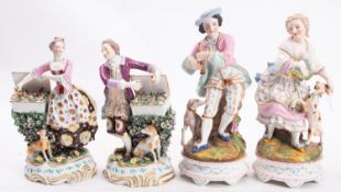 A pair of Continental figures of fruit sellers and two bisque figures the fruit sellers each
