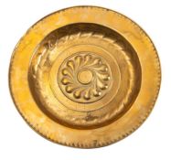 A Continental brass alms dish, probably Nuremberg, early 16th century; repousse worked throughout,