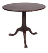A George II mahogany circular occasional table, mid 18th century; with single piece flip top,