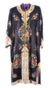 A Chinese hand-embroidered black silk robe, with figural and floral decoration,