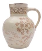 A North Devon slipware jug by Edwin Beer Fishley the cream slip sgraffito decorated with a sailing
