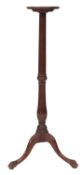 A mahogany torchere stand in George II style, 19th century; the circular top with moulded edges,