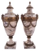 A pair of gilt metal mounted marble side urns in Neoclassical taste,
