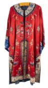A Chinese hand-embroidered red silk robe, with floral and figural decoration,