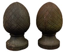 A pair of cast iron pier finials, 20th century; of ovoid form and cast with curved cross-hatching,