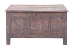 An oak coffer, 17th century with later elements; with hinged cover above a carved front,