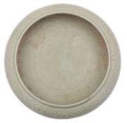 A Chinese celadon bowl of compressed form,