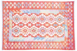 An Anatolian Turkish Kelim, the ivory field with two rows of serrated medallions,