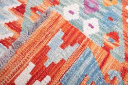 An Anatolian Turkish Kelim, the serrated lozenge field in vibrant colours of orange, green,