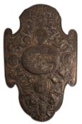 A Continental repoussé worked brass and pine backed model of a shield,