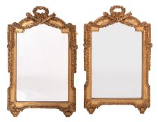 A pair of carved and gilt composition framed wall mirrors in Louis XVI style,