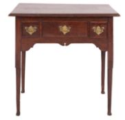 A George II oak lowboy side table, mid 18th century; the top with moulded edges,