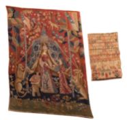 An early 19th century sampler, with alphabet in multi-colours, above a house flanked by flowers,