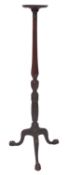 A mahogany torchere stand in George II style, 19th century; the circular top with moulded edges,