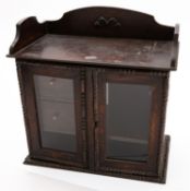 An oak and glazed smoker's cabinet, earl