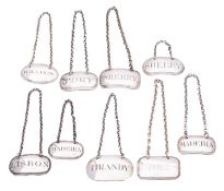 Nine George III or IV silver oblong or oval wine labels,