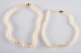 Two strands of pearls, a single strand of cultured pearls, 8.