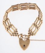 A 9ct yellow gold gate bracelet, with heart padlock & safety chain (detached on one side),