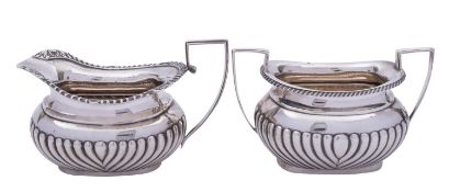 A matched silver milk jug and a sugar bowl,