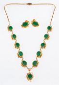 A necklace and earring set, a necklace of foliate and heart design set with eleven jade cabochons,