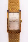 Juvenia an 18ct gold gentleman's wristwatch the rectangular silvered dial with baton numerals and