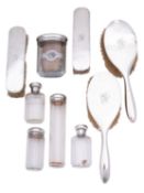 A George V leather vanity case with silver and glass bottles, silver tops by W.A.