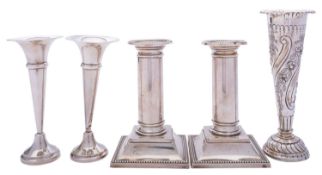 A pair of short Edward VII silver candlesticks by William Neale & Son, Birmingham 1908,