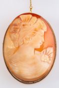 A 9ct yellow gold oval cameo brooch depicting a female bust with flower, measuring approx. 6.