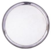 A George III silver salver by Elizabeth Jones, London 1786, of plain circular form,