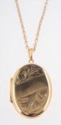 A locket and chain, an oval locket with foliate engraving, marked 9ct, measures approx. 3.0cm x 2.