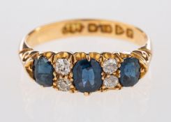 An 18ct yellow gold three stone ring, set with oval cut sapphires,