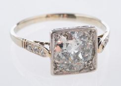 An Art Deco ring, centrally set with an old European cut diamond in a square designed setting,