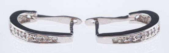 A pair of half hoop style earrings, each illusion set with five brilliant-cut diamonds, marked 750,