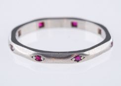 An Art Deco wedding band, of octagonal shape and interspaced with eight circular-cut rubies,