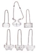A group of six silver wine labels comprising: three matching escutcheon wine labels- Sherry,