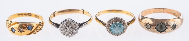 A group of four rings, including an 18ct yellow gold cluster ring set with a blue zircon,