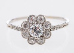 An Art Deco flowerhead ring, milgrain and claw set with old brilliant-cut diamonds,