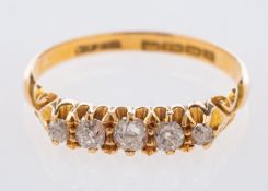 An 18ct yellow gold antique five stone ring, set with graduated old mine-cut diamonds, UK hallmark,