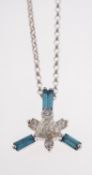 A contemporary diamond pendant and chain, the pendant is set with three baguette-cut blue diamonds,