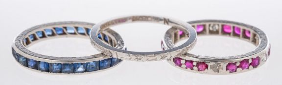 A group of three Art Deco rings, a wedding band with flower engraving, marked 'Bravingtons',