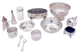 A small group of silver comprising; a part reeded sugar bowl, raised on a flared foot,