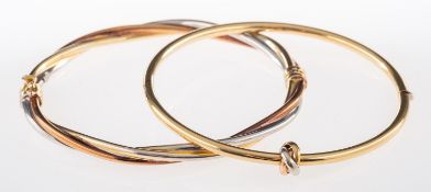 Two gold bangles, a three-coloured twist design bangle, hinged, inner diameter approx 5.