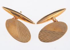 A pair of 9ct yellow gold cufflinks, oval in shape with engine turned engraving,
