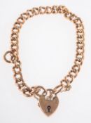 A curb bracelet, with heart padlock, safety chain and extra links, marked 9ct, length approx. 18.