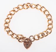 A 9ct rose gold curb bracelet, with heart padlock and safety chain, UK hallmark, length approx. 19.