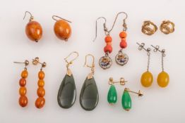 A group of earrings in amber, jade, mic