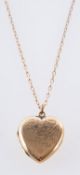 A heart shaped locket, with foliate engraving, marked to verso 9ct front & back,
