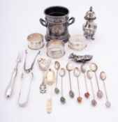 A group of silver items, comprising of; three napkin rings, a pepperette,