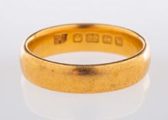 A 22ct yellow gold wedding band, UK hall